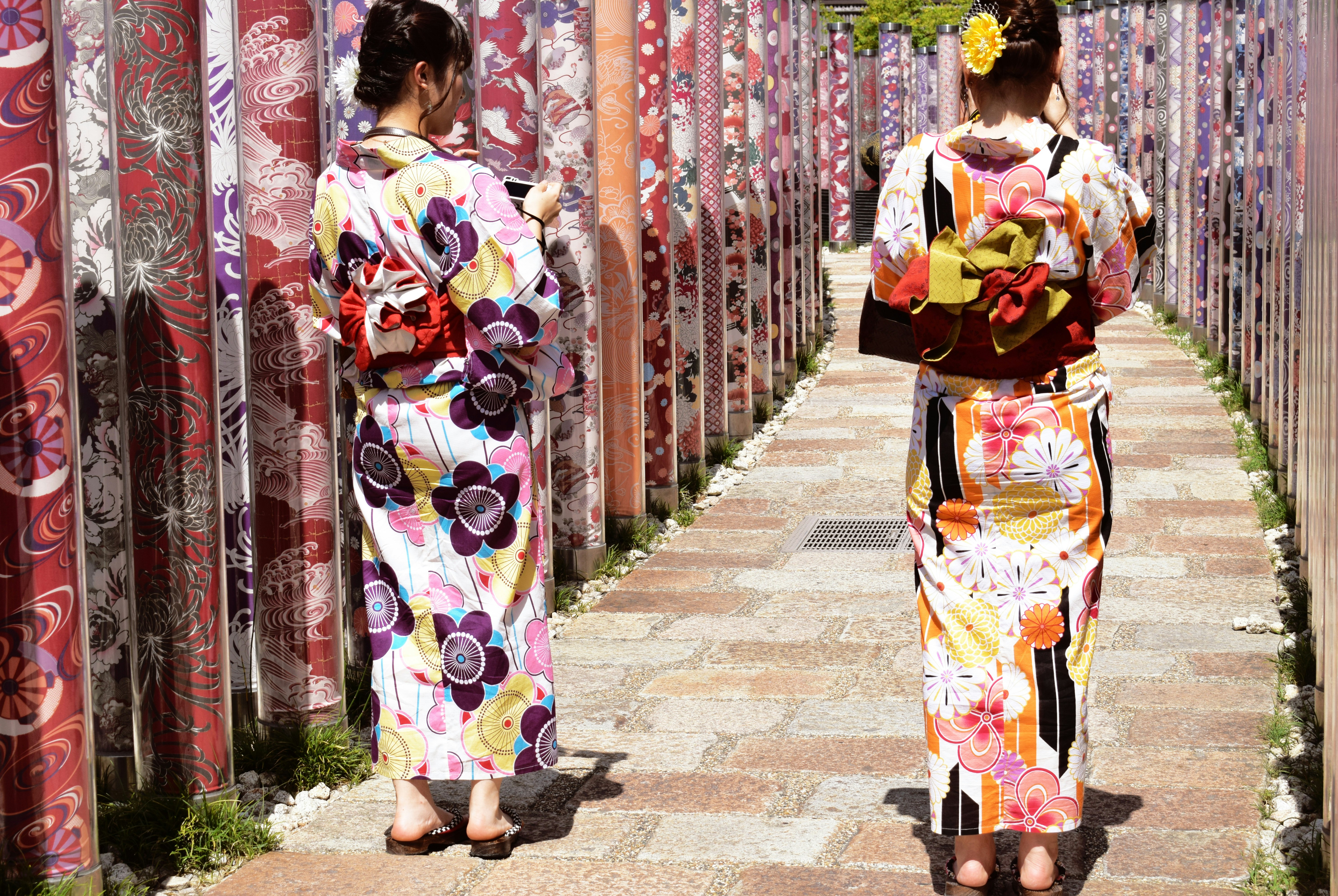 two women wearing floral traditional dresses